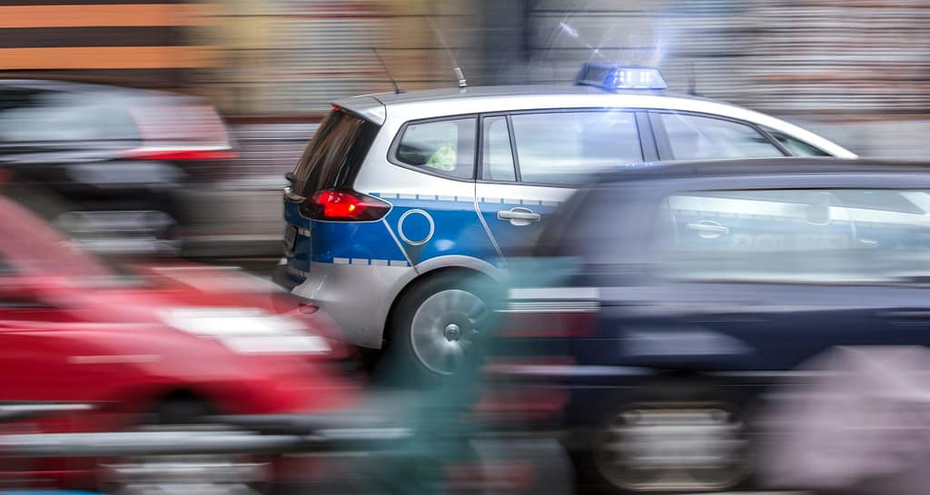 german police car speeding in city traffic
